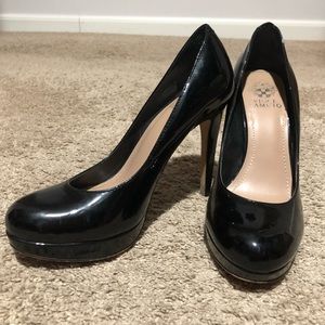 Black Vince Camuto patent leather pumps.